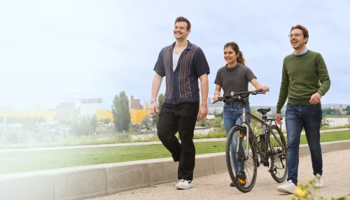Three young people walking in a park