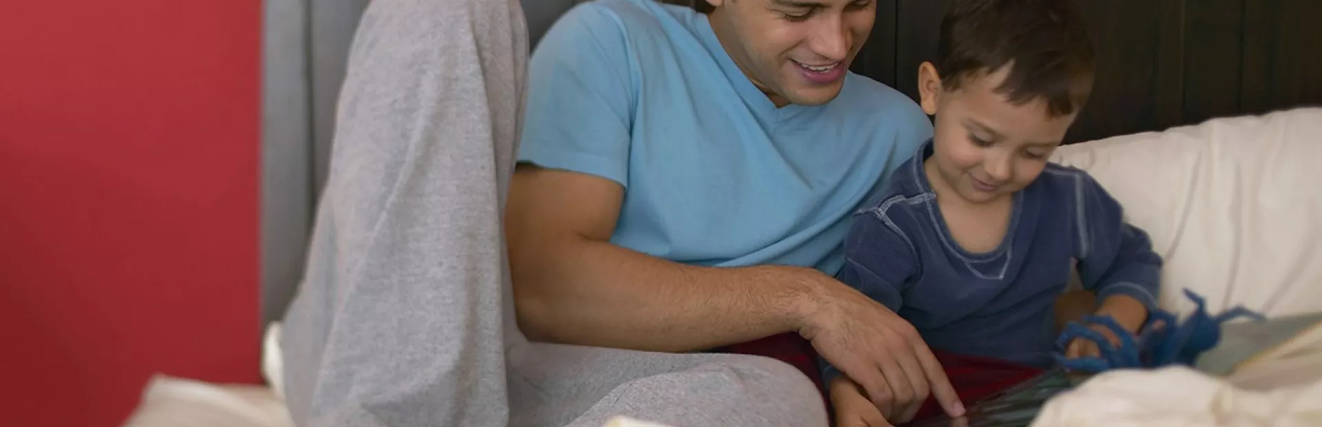 Father reading to son at home