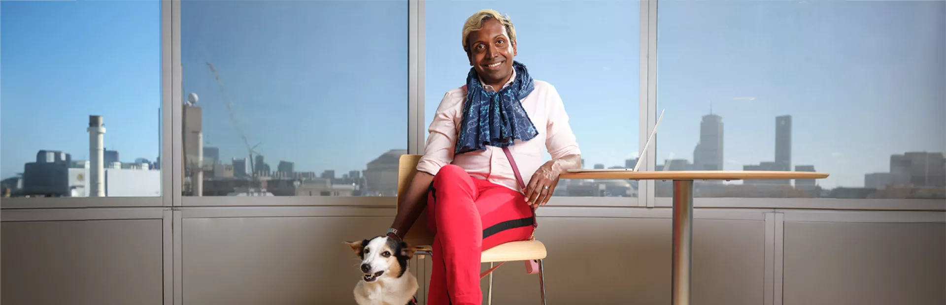 Kumar Veerapen, Senior Expert Data Science sitting with a dog in front of windows