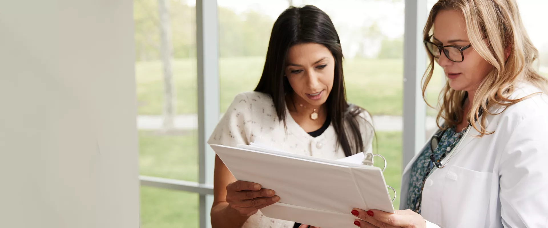 A business person and doctor looking at a report