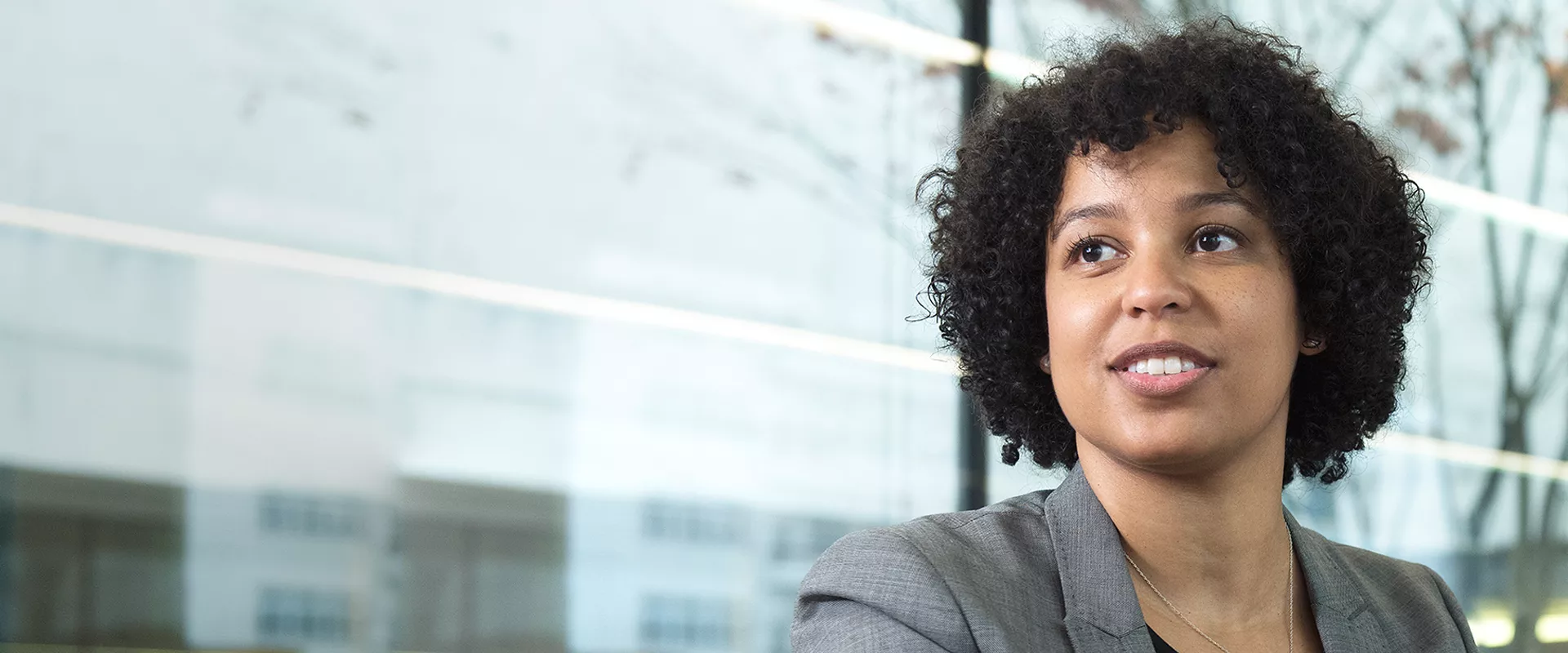 A black female Novartis associate looking into the distance