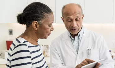 A doctor and a patient A patient asking a doctor about a clinical trial