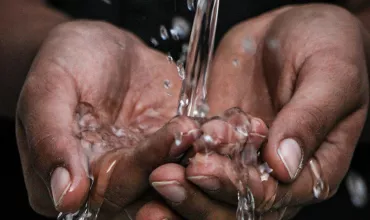 Hands holding water