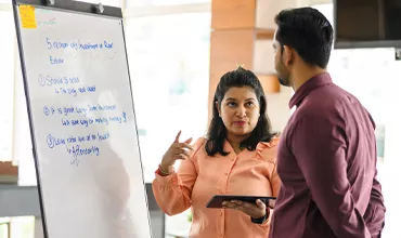 A business woman presenting her ideas to a male colleague