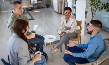 Group of business people sitting and discussing in circle