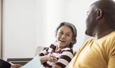 Two men talking in a waiting room