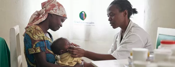 Doctor examining baby in Rwanda Doctor examining baby in Rwanda