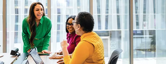 A group of three female business professionals in meeting