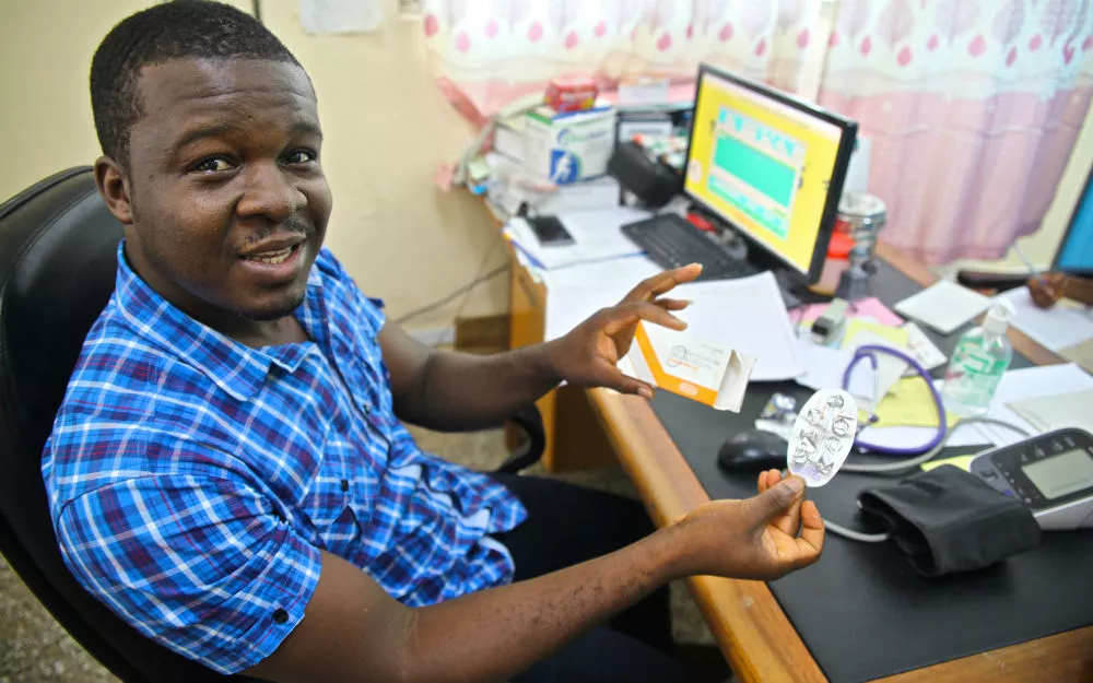 Doctor with blood pressure monitor and computer A doctor based at St. Martin’s Hospital holds a blood pressure monitor.
