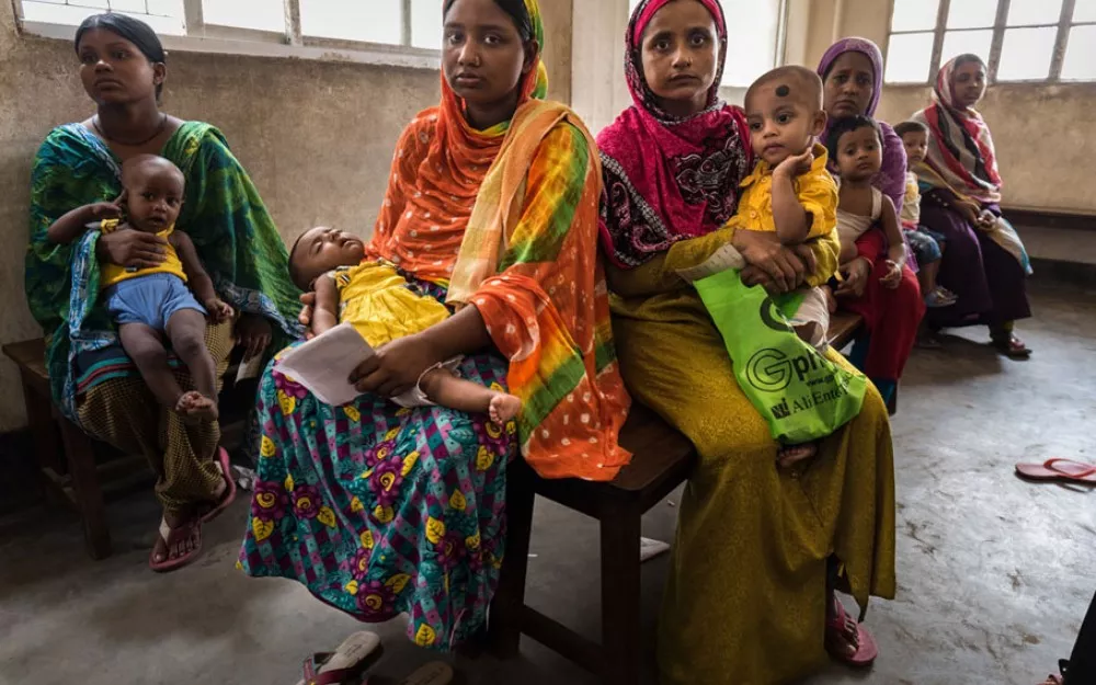 Mothers wait in a clinic in Dhaka, Bangladesh for treatment for their children, who are suffering from pneumonia. Mothers wait in a clinic in Dhaka, Bangladesh for treatment for their children, who are suffering from pneumonia.
