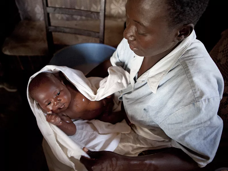 Nurse looking after baby in Kenya Nurse looking after baby in Kisumu, Kenya