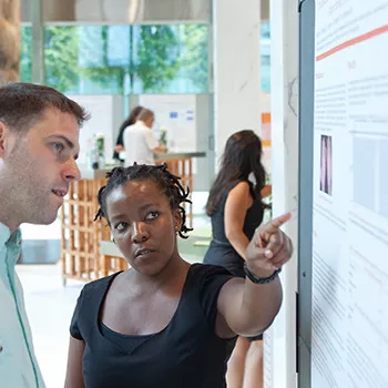 Young scientist presents her work Dr. Ngcungcu presents her scientific paper to a colleague.
