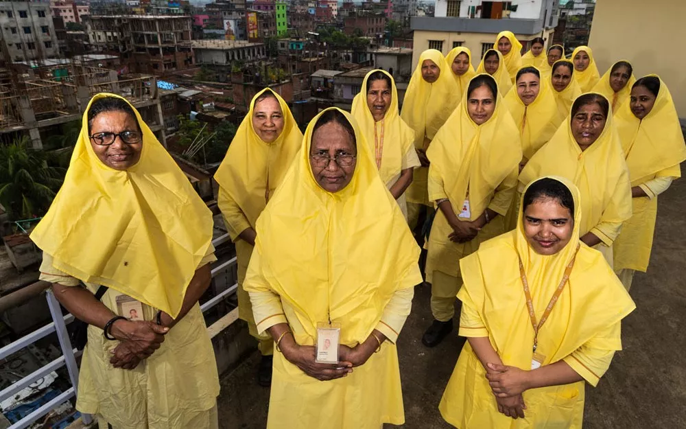 Yellow-robed health workers routinely visit homes in poor neighborhoods in Dhaka, Bangladesh as part of an ongoing fight against child pneumonia. Yellow-robed health workers routinely visit homes in poor neighborhoods in Dhaka, Bangladesh as part of an ongoing fight against child pneumonia.
