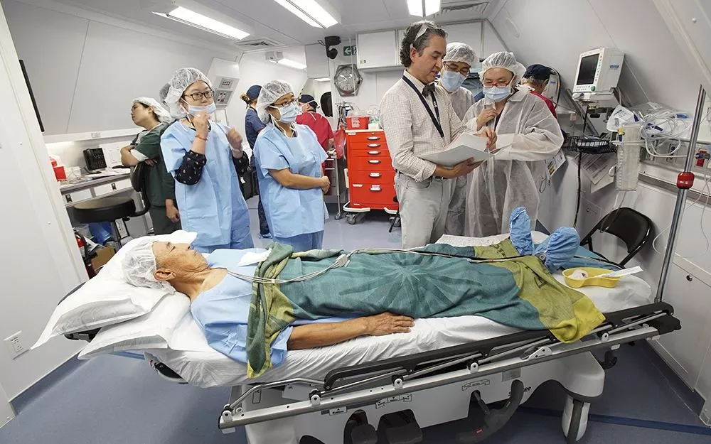 Dr. Lehmann discusses pre-surgery procedures as a part of hands-on training aboard the hospital