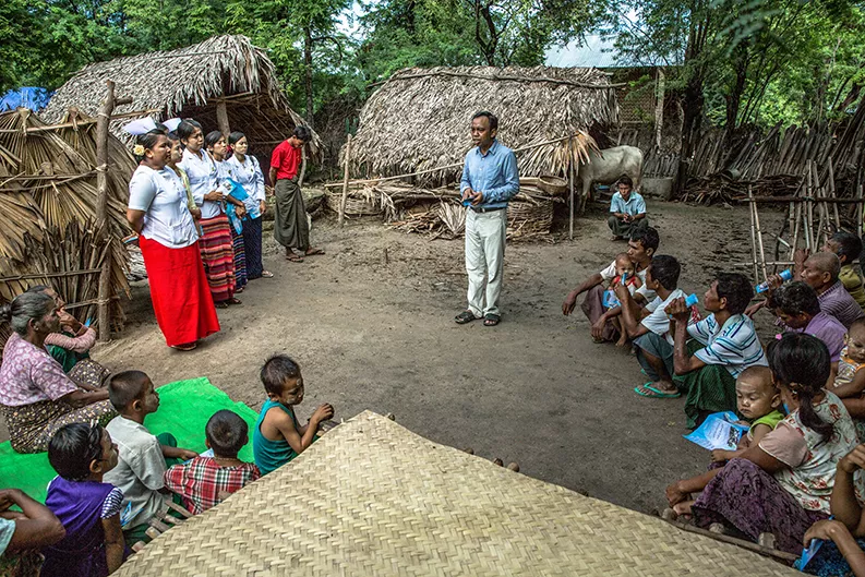 A man teaches a community in Myanmar about leprosy awareness and prevention A man teaches a community in Myanmar about leprosy awareness and prevention