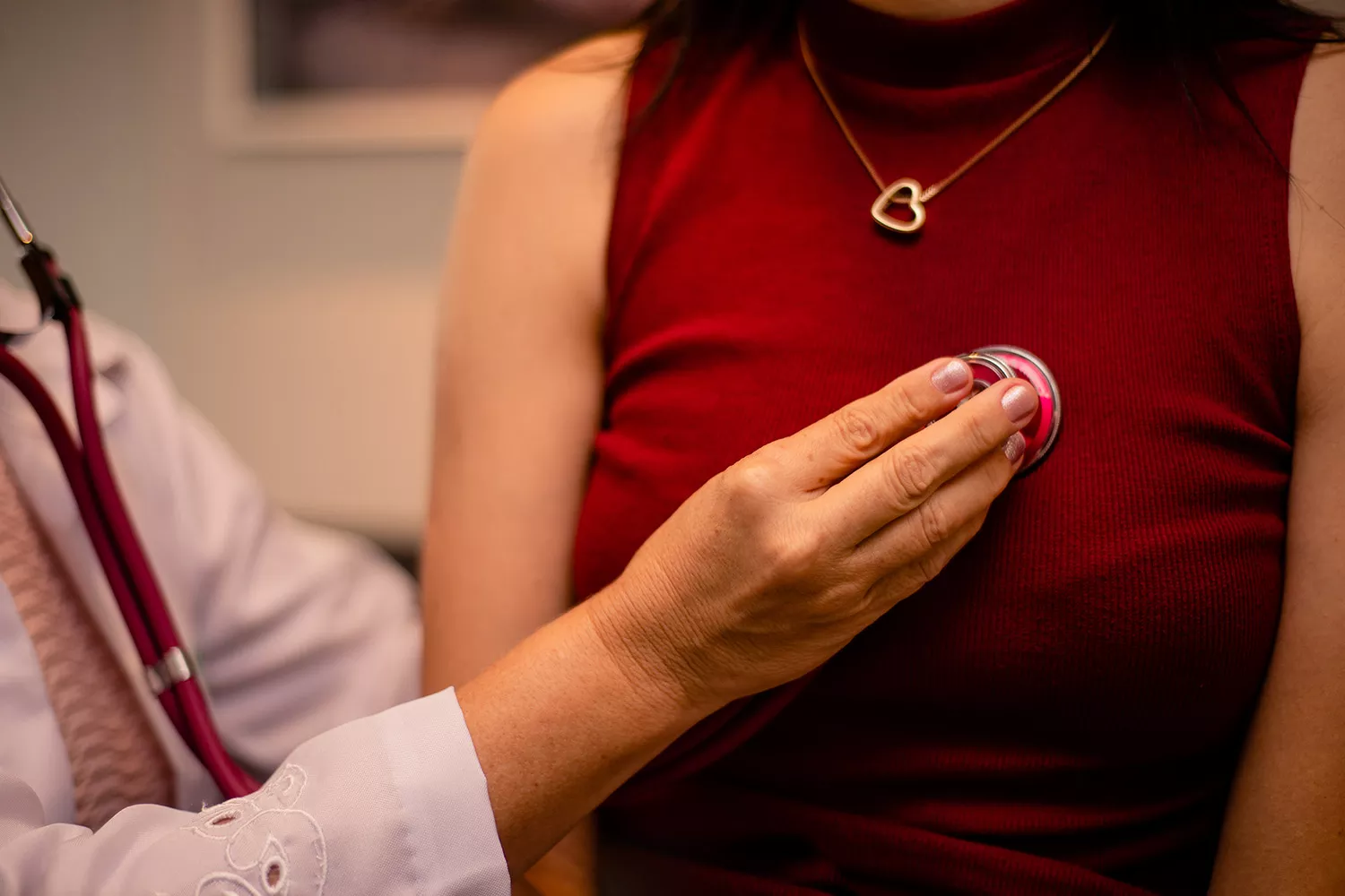 Doctor using a stethoscope on a patient Doctor using a stethoscope on a patient
