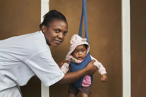 Doctor in Rwanda weighing a baby Doctor in Rwanda weighing a baby