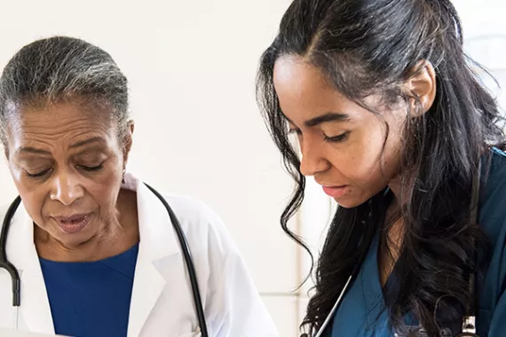 Image of two healthcare professionals interacting