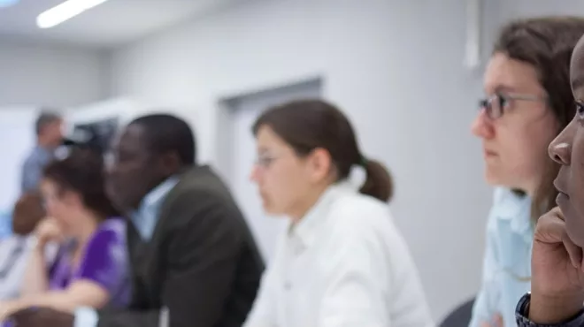 Dr. Thandiswa Ngcungcu listens to a seminar on drug discovery.