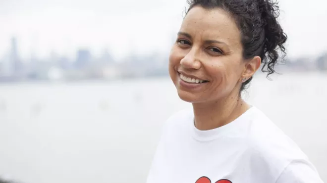 A kidney patient is smiling at the camera.