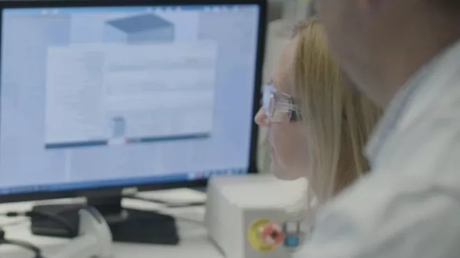 Scientists looking at data on screens