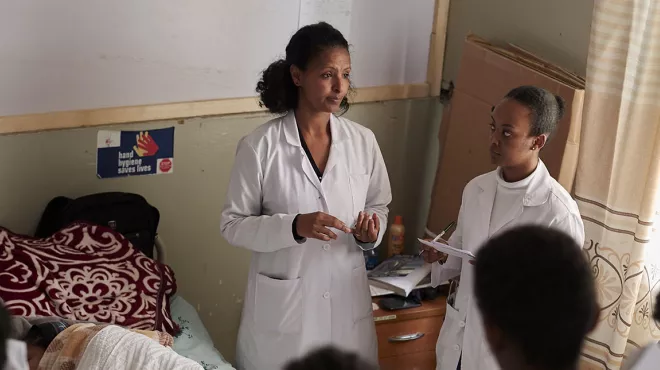 Team of doctors in a patient's hospital room